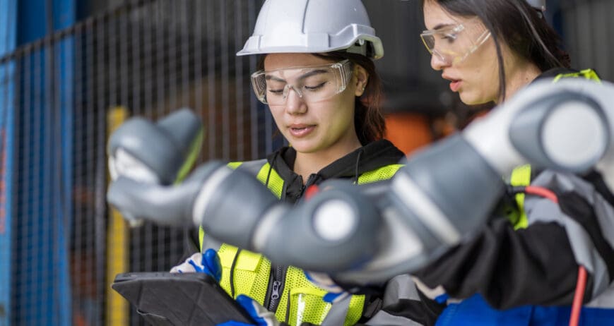 A team of female engineers meeting to inspect computer-controlled steel welding robots. Plan for rehearsals and installation for use.