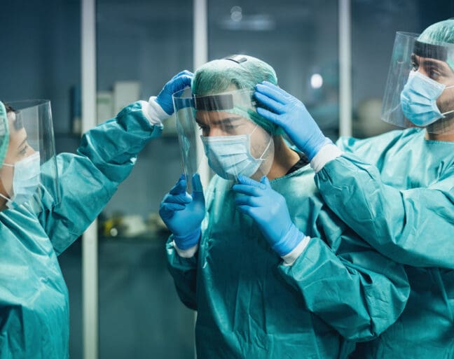 Doctors wearing ppe equipment face surgical mask and visor fighting against corona virus outbreak - Health care and medical workers concept