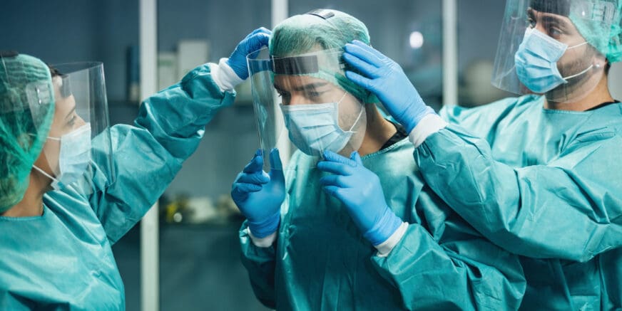 Doctors wearing ppe equipment face surgical mask and visor fighting against corona virus outbreak - Health care and medical workers concept